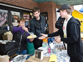 Denise Couture, Julian Foreman Development Officer for Ronald McDonald House Toronto, serve Evan Monroe corn during Sunday's Korn for Kids corn roast fundraiser for Ronald McDonald House Toronto.