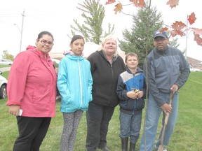 The Grant family planted a tree in memory of their dog Barkley during the 14th annual tree planting ceremony for the Mud Creek Pet Memorial Trail. From left: Alyssa, Sabannah, Debbie, Gavin and Tony. Another 20 trees were planted along the trail in south Chatham on Oct. 4.