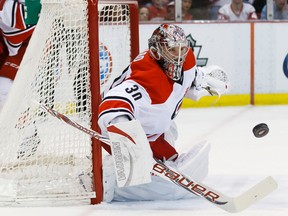 Carolina Hurricanes goalie Cam Ward (30) makes a save in the first period against the Detroit Red Wings. (Rick Osentoski-USA TODAY Sports)