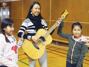 Piikani School’s principal Crystal Good Rider and Grade 5 students Tiny Little Plume, and Lexi Yellow Horn, pose with Voyageur on September 30, 2014. Photo provided by George Hall.