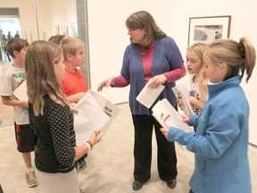 Linda Lamoureux, volunteer co-ordinator for the Beyond Classrooms program, talks to students about their journals as they spend a week in the Agnes Etherington Art Centre. (Michael Lea/The Whig-Standard)
