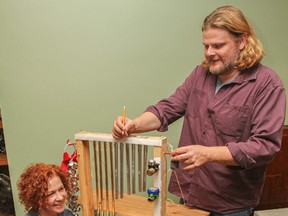 Krista and Clayton Garrett with their homemade sound effects machine at the King's Town Players rehearsal space on  October 8. (JULIA MCKAY/The Whig-Standard)