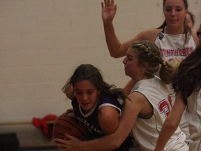 Lo-Ellen's Andrea Zulich protects the ball from Macdonald Cartier defenders during senior girls high school basketball action at Macdonald Cartier on Thursday night.