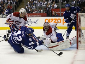 Leafs’ Tyler Bozak tries to swipe one past Habs goalie Carey Price on Wednesday while Phil Kessel looks on. Both Leafs and linemate James Van Riemsdyk were minus-twos on the night. (CRAIG ROBERTSON/TORONTO SUN)