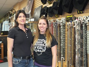 Debb Pitel (left) stands beside one of her employees in Bits 'N Buckles Western Wear store in Petrolia. Pitel is hosting a fashion show fundraiser to raise money for suicide prevention.
BRENT BOLES/ QMI Agency