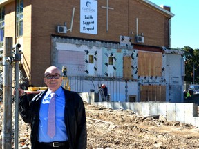 Rev. Philip Newman stands in front of the construction site at Riverside United Church in London. The $3 million project should be complete by next summer.