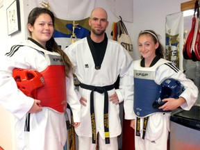 Danielle Ennett (left), head instructor Mark Warburton and Chloe Pretty stand in Petrolia Taekwondo. Ennett and Pretty are both ranked as top martial artists in the province heading into the Ontario team trials.
BRENT BOLES/ QMI Agency