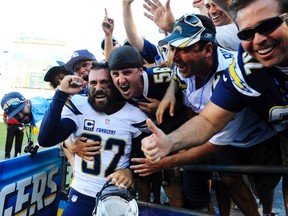 San Diego Chargers safety Eric Weddle (32) celebrates with fans following a win against the Dallas Cowboys at Qualcomm Stadium on Sep 29, 2013 in San Diego, CA, USA. ( Christopher Hanewinckel/USA TODAY Sports)