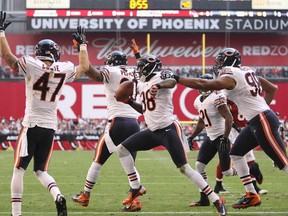 The Chicago Bears defense celebrate a touchdown by Zackary Bowman (38) against the Arizona Cardinals in the first half during their NFL football game in Phoenix, Arizona December  23, 2012. (REUTERS/Darryl Webb)