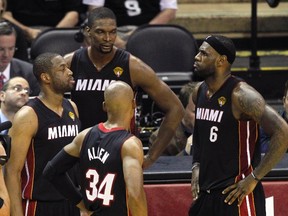 Miami Heat players (L-R) Dwyane Wade, Chris Bosh, Ray Allen, and LeBron James wait during a timeout against the San Antonio Spurs during the first half in Game 5 of their NBA Finals basketball series in San Antonio, Texas, June 15, 2014. (REUTERS/Mike Stone)
