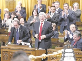 Prime Minister Stephen Harper stands to vote in favour of a government motion to participate in U.S.-led air strikes against Islamic State militants operating in Iraq, in the House of Commons on Parliament Hill in Ottawa this week. (Chris Wattie/Reuters)