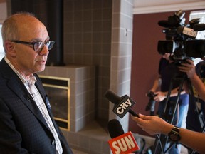 Former Edmonton mayor and current Progressive Conservative candidate Stephen Mandel (left) speaks with the media at his Edmonton-Whitemud campaign launch at Riverbend Community Centre in Edmonton, Alta., on Sunday, Oct. 5, 2014. Four by-elections are scheduled across the province for Oct. 27. Ian Kucerak/Edmonton Sun