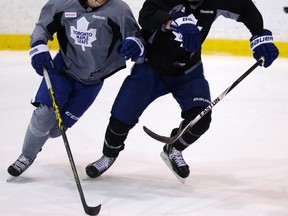 Maple Leafs’ Carter Ashton (left) and Cody Franson chase the puck during practice on Friday. Franson might sit out Saturday's game. (CRAIG ROBERTSON/TORONTO SUN)