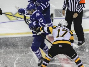 Kingston Frontenacs Ryan Kujawinski battles with Mississauga Steelheads Bryson Cianfrone off the face off during the first period of Ontario Hockey League action at the Rogers K-Rock Centre on Friday, October 10, 2014.  JULIA MCKAY/Kingston Whig-Standard/QMI Agency