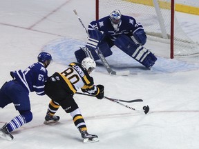 Kingston Frontenacs' Mack Lemmon tries to evade the Mississauga Steelheads' Adam Donnelly and get get a shot at Spencer Martin during the first period of Ontario Hockey League action at the Rogers K-Rock Centre on Friday night. (Julia McKay/The Whig-Standard)