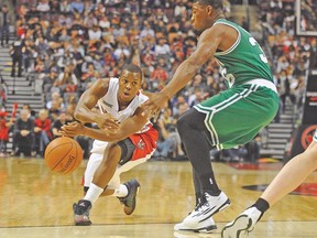 Raptors point guard Kyle Lowry passes the ball by Boston Celtics’ Marcus Smart during Friday night’s pre-season game at ACC. (USA TODAY SPORTS)