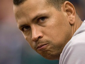 New York Yankees slugger Alex Rodriguez watches from the dugout railing during the 11th inning of their MLB American League baseball game against the Tampa Bay Rays in St. Petersburg, Florida in this August 25, 2013 file photo. (REUTERS/Steve Nesius/Files)