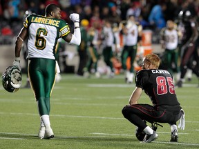 Ottawa RedBlack Matt Carter gets an ear full from Edmonton Eskimo Alonzo Lawrence after Edmonton defeated Ottawa 10-8 Friday night.  Tony Caldwell/Ottawa Sun/QMI Agency