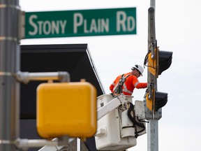 EPCOR crews replace streetlights and signals at Stony Plain Road and 153 Street in Edmonton, Alta., on Friday, Aug. 22, 2014. Ian Kucerak/Edmonton Sun/ QMI Agency