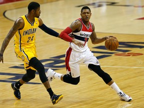 Washington Wizards guard Bradley Beal (3) dribbles the ball as Indiana Pacers forward Paul George (24) defends in the first quarter in game six of the second round of the 2014 NBA Playoffs at Verizon Center on May 15, 2014 in Washington, DC, USA. (Geoff Burke/USA TODAY Sports)