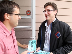 St. Boniface council candidate Matt Allard (right) speaks with constituent Pat Fortier.
