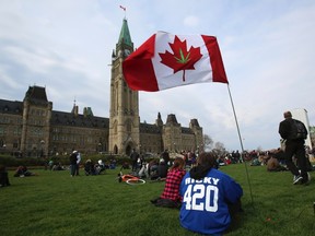 A Canadian flag with a marijuana leaf is flown during a 4/20 rally to demand the legalization of marijuana on Parliament Hill in Ottawa April 20, 2012. Marijuana enthusiasts across Canada gather by the thousands every year on April 20 for an international celebration-cum-protest for marijuana legalization.  REUTERS/Patrick Doyle