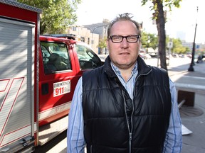 City councillor Scott Fielding, standing beside a Winnipeg Fire Department vehicle on Main Street near Logan Avenue on Sat., Oct. 11, 2014, called a $100 fee to apply for a 911 call centre job 'ridiculous'.