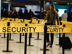 Passengers make their way in a security checkpoint at the International JFK airport in New York October 11, 2014. (REUTERS/Eduardo Munoz)