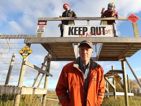 Vince Rattai of Deer Meadow Farms north of Winnipeg, along with helpers Sloan Reimer (left) and James Hayes, stand at the zombie gate, part of their forbidden forest.