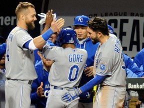 Kansas City Royals players congratulate Terrance Gore after he scored in the ninth inning against the Baltimore Orioles during Game 2 of the ALCS yesterday. (Getty Images/AFP)