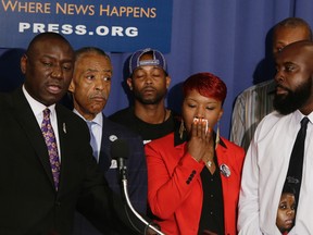 (L-R front) Brown family attorney Benjamin Crump, U.S. civil rights leader Rev. Al Sharpton, the parents of Michael Brown, Lesley McSpadden and Michael Brown, Sr. appear at a news conference at the National Press Club in Washington September 25, 2014. Five people were arrested and two police officers injured in renewed violence overnight on the streets of Ferguson, Missouri, sparked by a fire that destroyed a shrine to Michael Brown, a teenager killed by a police officer last month. REUTERS/Gary Cameron