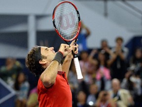 Roger Federer of Switzerland reacts after defeating France's Gilles Simon in the men's singles final at the Shanghai Masters 1000 tennis tournament held in the Qizhong Tennis Stadium in Shanghai on October 12, 2014.    AFP PHOTO / JOHANNES EISELE
