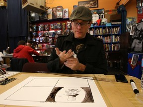 Mark Raven-Jackson puts in the finishing touches to his comic book at Happy Harbour Comics in Edmonton, Alberta on Sunday,Oct. 12, 2014.  16 artist came together to produce a comic in 24 hours and raise funds for Literacy Alberta and for the Boys and Girls Club.  Perry Mah/Edmonton Sun/QMI Agency