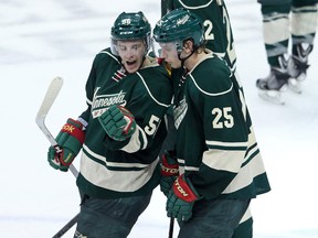 Minnesota Wild forward Mikael Granlund (64) celebrates his goal with forward Zach Parise (11) and defenseman Jonas Brodin (25) during the third period against the Chicago Blackhawks in game three of the second round of the 2014 Stanley Cup Playoffs at Xcel Energy Center.  (Brace Hemmelgarn-USA TODAY Sports)