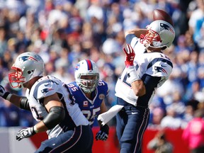 New England Patriots quarterback Tom Brady (12) throws a pass under pressure by the Buffalo Bills defensive tackle Kyle Williams (95) during the 1st half at Ralph Wilson Stadium. (Kevin Hoffman-USA TODAY Sports)