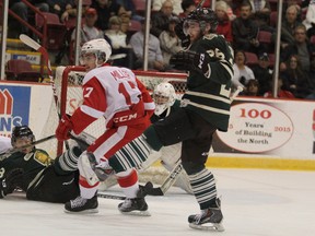 David Miller (17) and Michael Bunting (27), of Soo Greyhounds, press goalie Michael Glugovaz, of London Knights during first-period action  at Essar Centre in Sault Ste. Marie, Ont., on Sunday, Oct. 12, 2014. (BRIAN KELLY/THE SAULT STAR/QMI AGENCY)