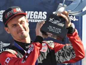 Canadian air race pilot Pete McLeod accepts his trophy after winning the Red Bull Air Race event in Las Vegas Sunday October 12, 2014. CHRIS MONTANINI\LONDONER\QMI AGENCY