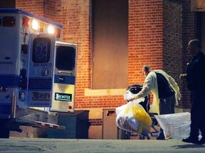 A man collects and bags items behind the ambulance used to transport a patient with possible Ebola symptoms to Beth Israel Deaconess Medical Center in Boston, Massachusetts October 12, 2014.   REUTERS/Brian Snyder
