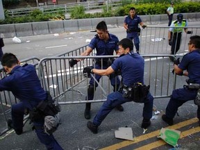 Police remove barricades erected by pro-democracy protesters at the main protest site in Admiralty in Hong Kong October 13, 2014.  .  REUTERS/Carlos Barria