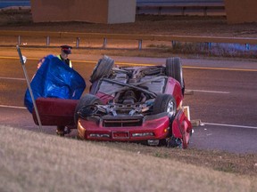 A police officer checks the scene after a fatal accident on Yellowhead Trail Sunday evening. (Max Maudie/Edmonton Sun)