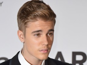 This May 22, 2014 file photo shows Canadian singer Justin Bieber as he arrives for the amfAR 21st Annual Cinema Against AIDS during the 67th Cannes Film Festival at Hotel du Cap-Eden-Roc in Cap d'Antibes, southern France.  (QMI files/AFP)