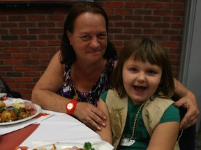 Michelle Desrosiers and her granddaughter Emma White get set to dig in to their Thanksgiving dinner at The Mission Monday morning. Chef Ric Watson figures he's served up 260,000 turkeys in his 13 years at the downtown shelter -- including the ones provided at Christmas. (DOUG HEMPSTEAD/Ottawa Sun)