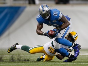 Calvin Johnson of the Detroit Lions tries to avoid the tackle by Tramon Williams of the Green Bay Packers in the fourth quarter at Ford Field on September 21, 2014. (Gregory Shamus/Getty Images/AFP)