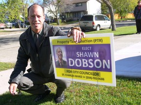 St. Charles candidate Shawn Dobson stands with one of his election lawn signs. Dobson had more than 60 of his signs taken down in St. Charles ward with some of them getting put into residents' recycling bins. (GLEN DAWKINS/Winnipeg Sun/QMI Agency)