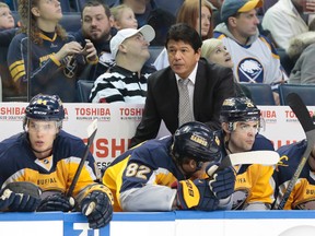 Buffalo Sabres head coach Ted Nolan watches play from behind the bench during the first period against the Calgary Flames at First Niagara Center on December 14, 2013. (Kevin Hoffman/USA TODAY Sports)