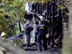 Members of the Ontario Fire Marshal's Office investigate the scene of a fatal fire on Langstaff Line west of Tupperville Monday afternoon. Chatham-Kent police said there is no indication of foul play at this point. (Diana Martin, The Daily News)