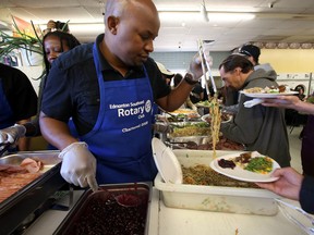 Volunteers serve up some noodles during the 22nd annual Thanksgiving Dinner at the Millbourne Laundromat in Edmonton on Monday. (PERRY MAH/Edmonton Sun)