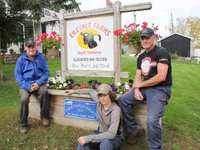 Three generations of Sleeth farmers, Ron, left, Brody and Paul, pose in front of the family farm's sign with its new plaque on Saturday. Eilevale Farms in Battersea was chosen as one of the top ten BMO Ontario Farm Families of 2014. (Julia McKay/The Whig-Standard)