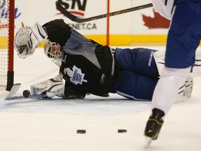 James Reimer dives to make a save during Maple Leafs practice on Monday. (Jack Boland/Toronto Sun)