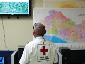 A member of El Salvador's Red Cross observes a screen after a magnitude 7.3 earthquake struck late on Monday, at a Red Cross office in San Salvador October 13, 2014. (REUTERS/Jose Cabezas)